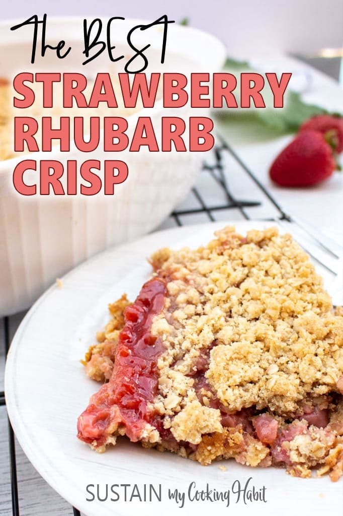 Close up image of a piece of baked strawberry rhubarb crunch on a white plate.