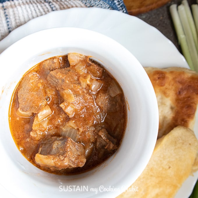 beef goulash in a bowl served with bread