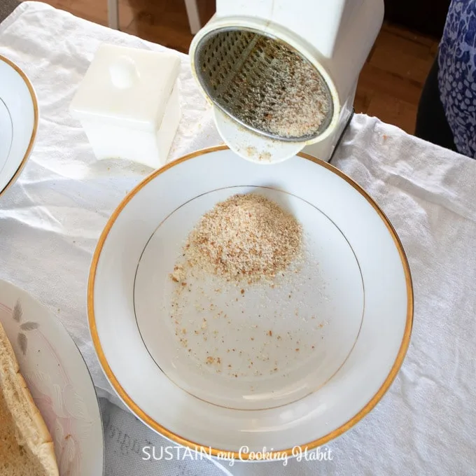 Using a kitchen grinder to make homemade bread crumbs.