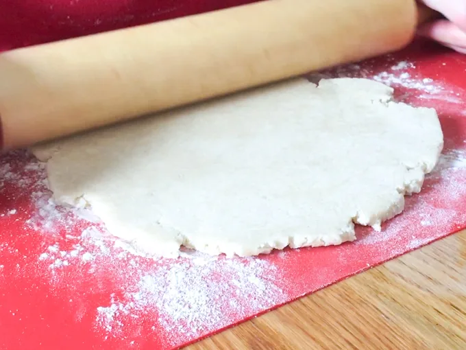 rolling out the pie dough and cutting 1" wide strips for lattice crust