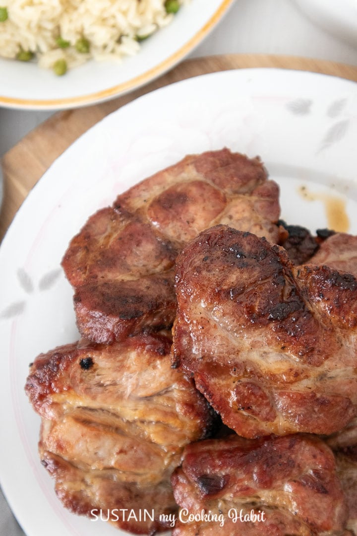 Close up of grilled pork shoulder pieces.