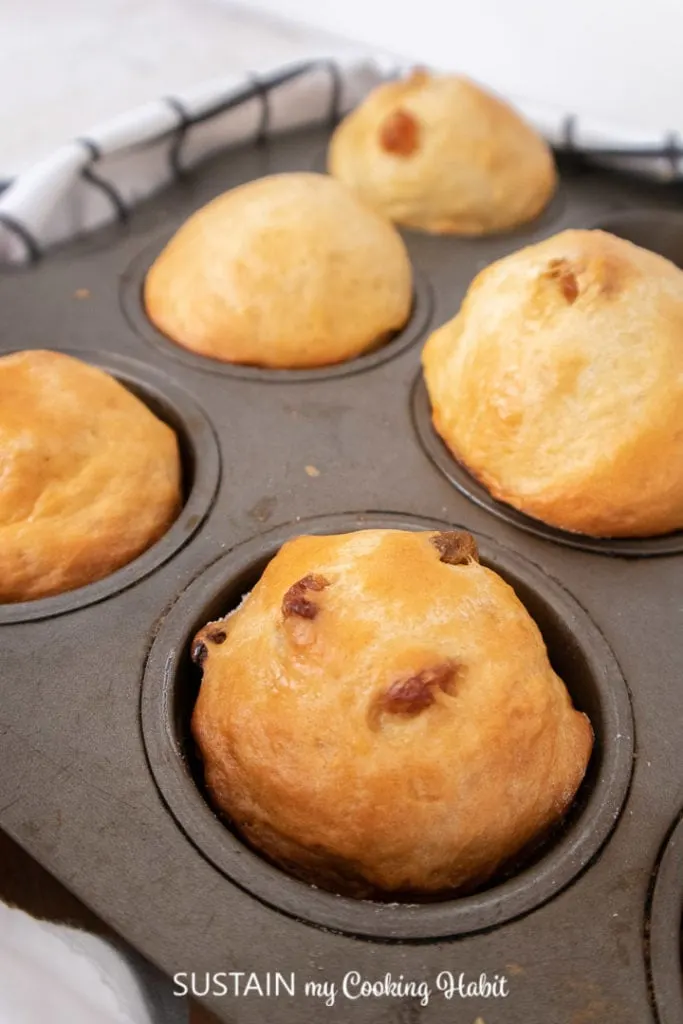 Close up of sweet bread buns in a muffin tin.