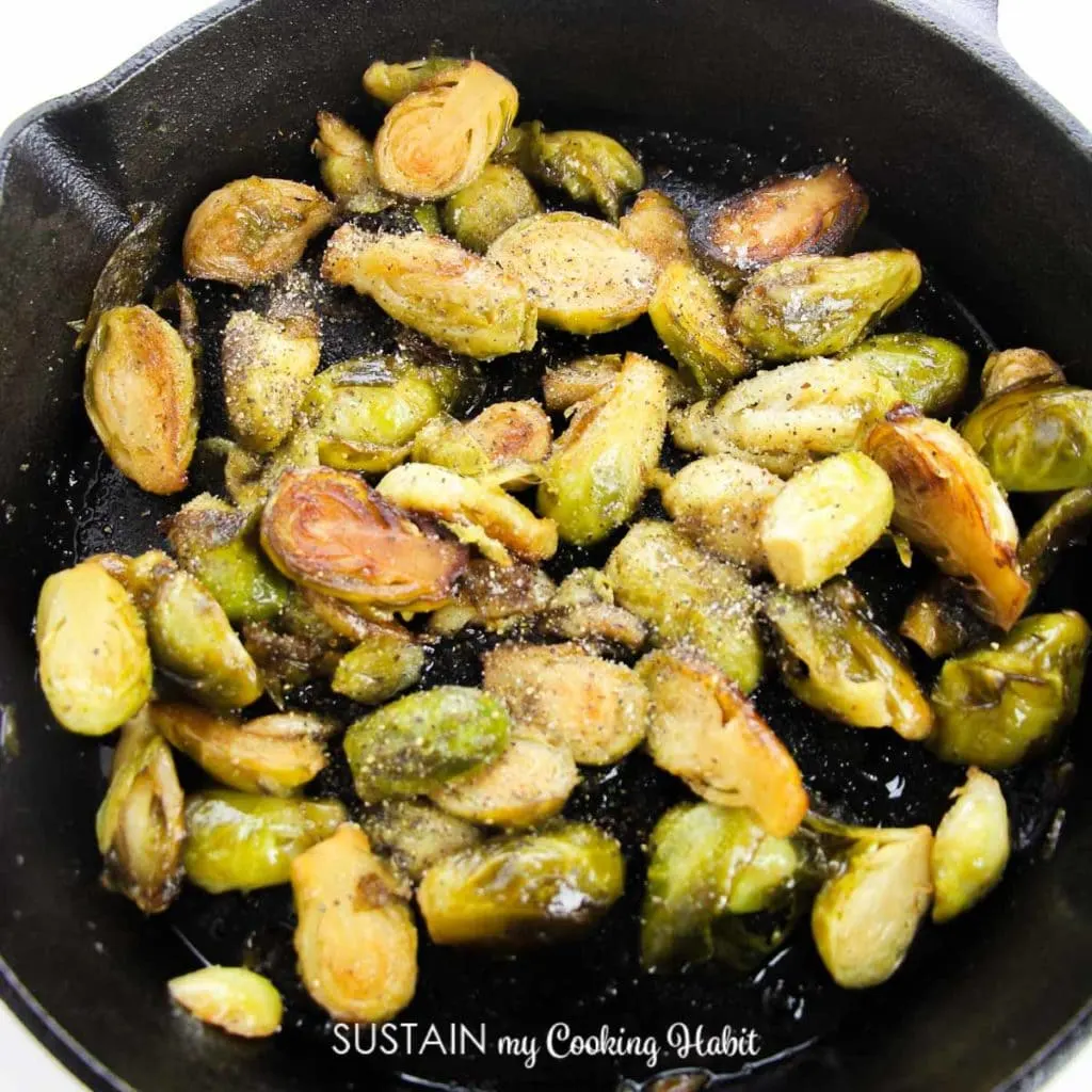 Drizzling maple syrup ,salt and pepper on the halved brussel sprouts in a skillet.