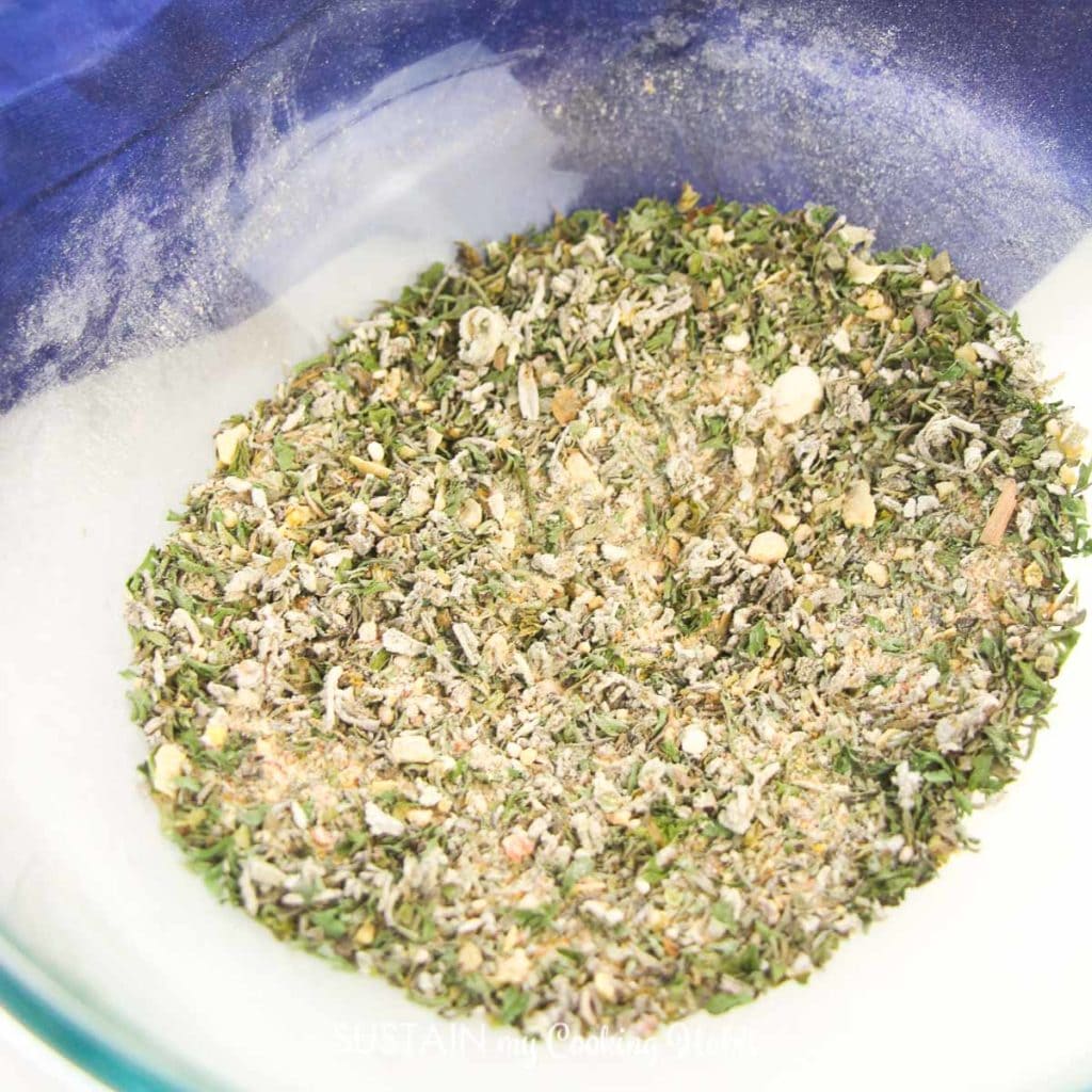 Mixing the garlic and herb seasoning mix in a bowl.