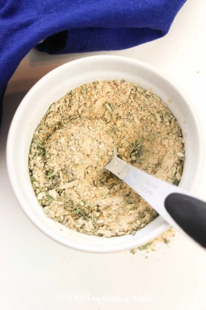 Scooping the garlic and herb seasoning mix.