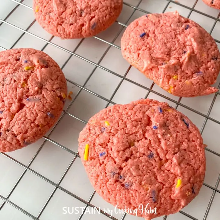 Close up of a baked strawberry cake mix cookies placed on a cooling rack.