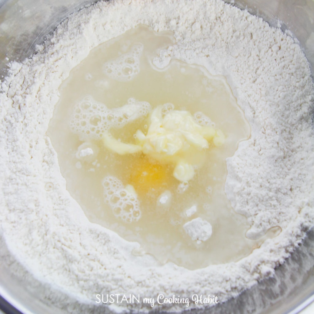 Adding an egg and butter to the mixed ingredients.