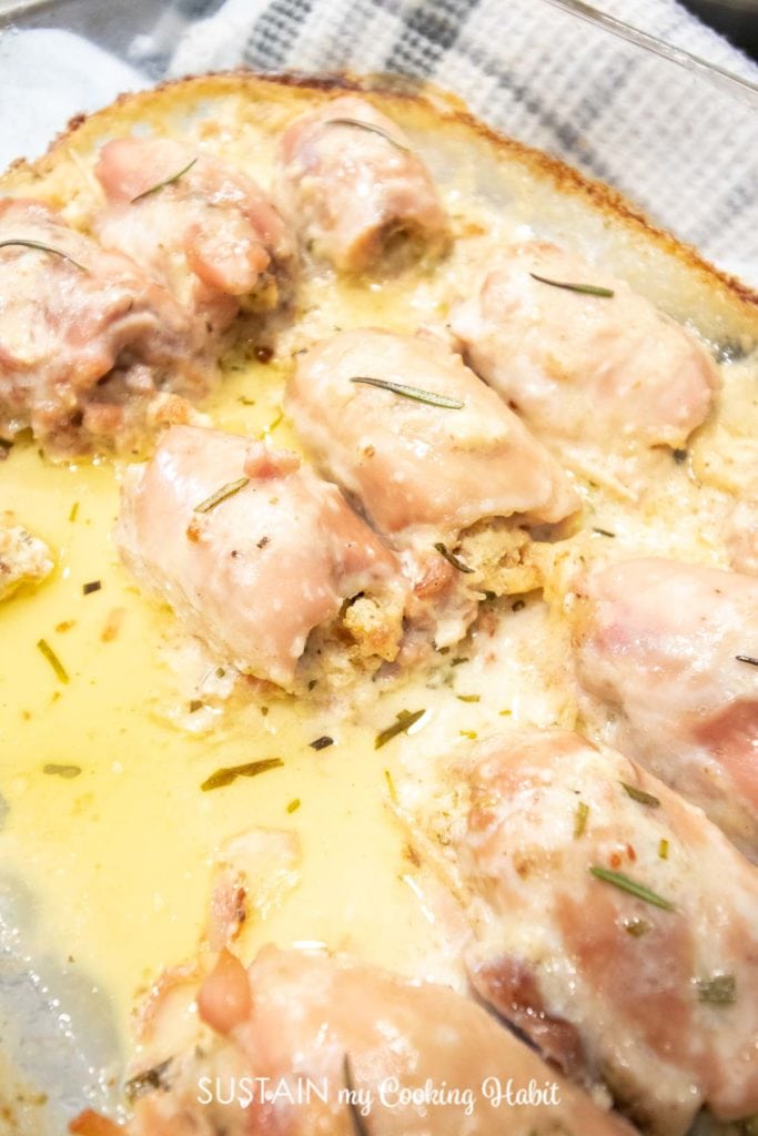 Cooked rosemary chicken thighs in a pan.