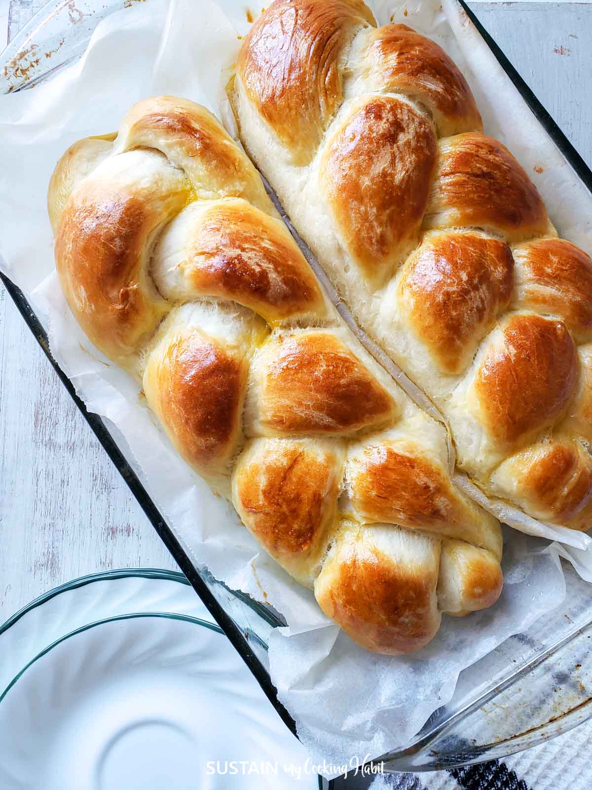 Two loaves of breaded bread in a pan.