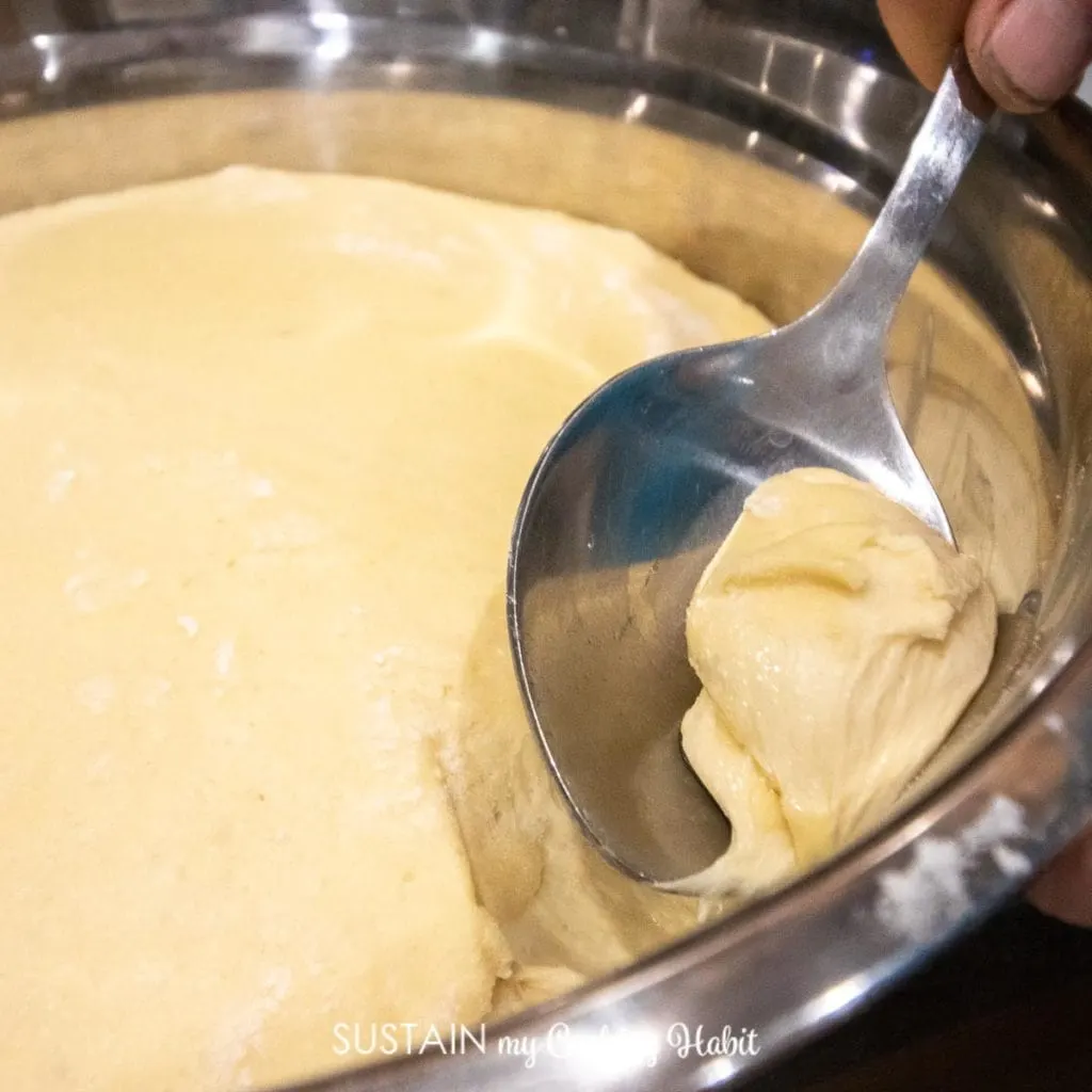 Scooping dough with a spoon.