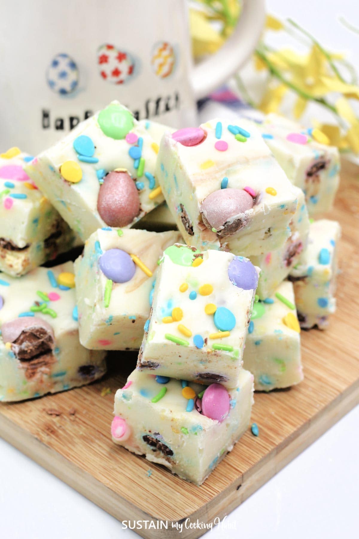 White chocolate Easter fudge loaded with colorful sprinkles, chocolate eggs and M&Ms.