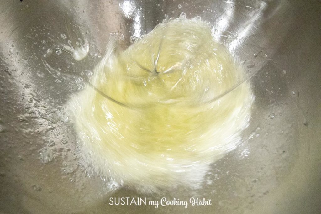 Beating egg whites using a stand mixer.