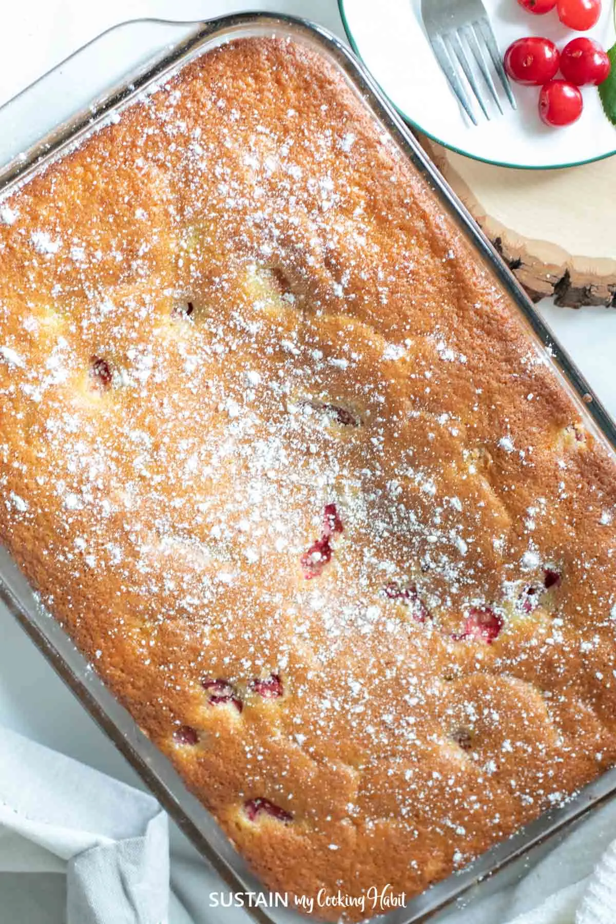 over view image of sour cherry cake with icing sugar