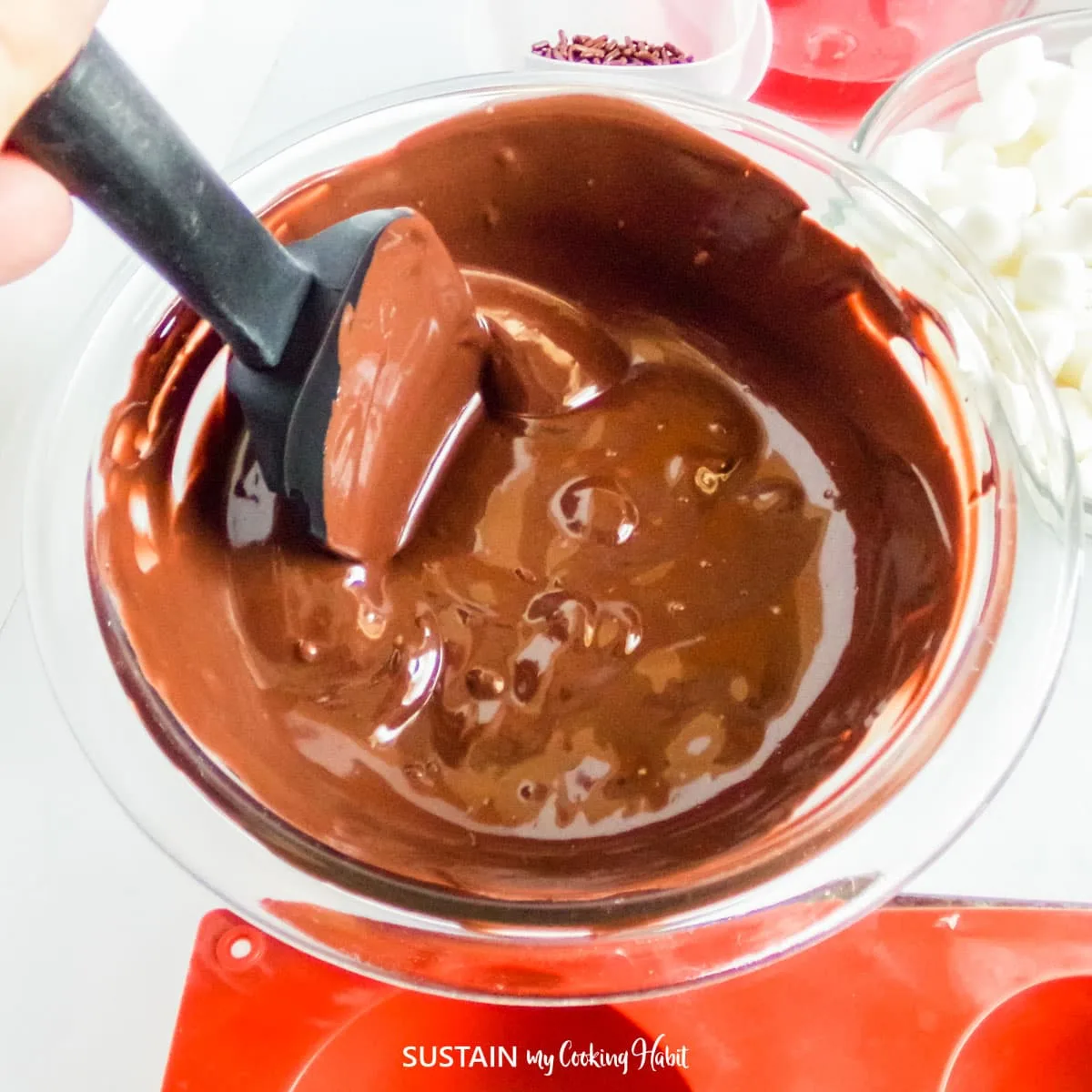 Melting chocolate in a glass bowl.