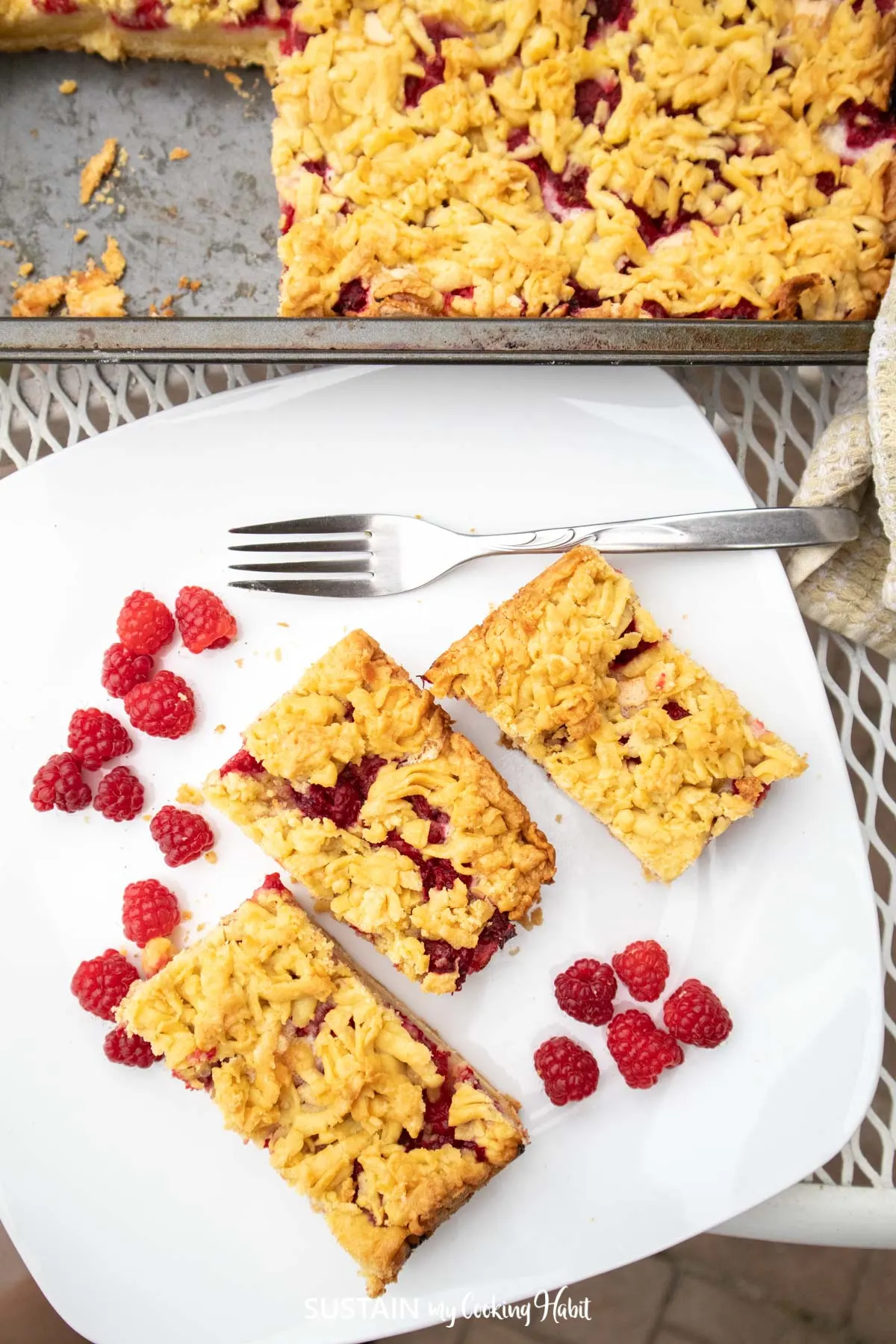 Overhead view of raspberry dessert squares on a plate.