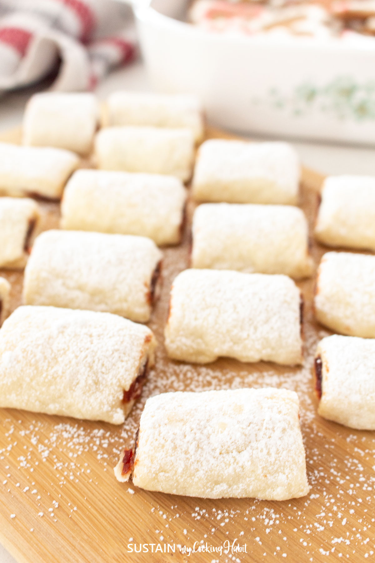 Jam filled cookie rolls sprinkled with powdered sugar.