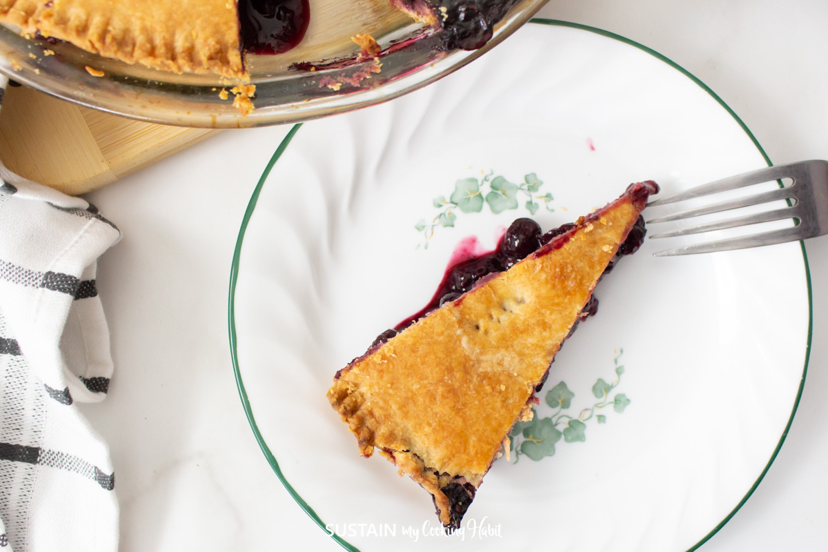 Overheard view of a slice of mixed berry pie on a plate.