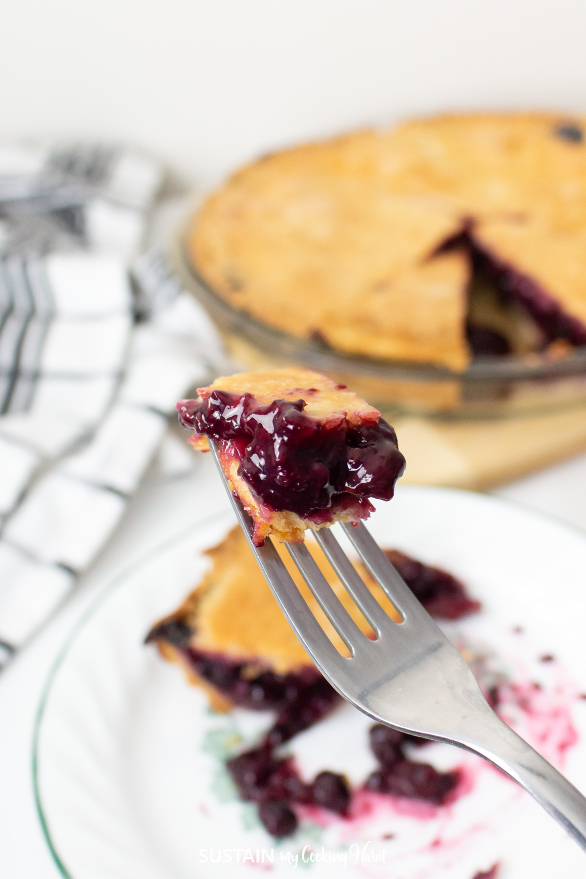A piece of mixed berry pie on a fork.