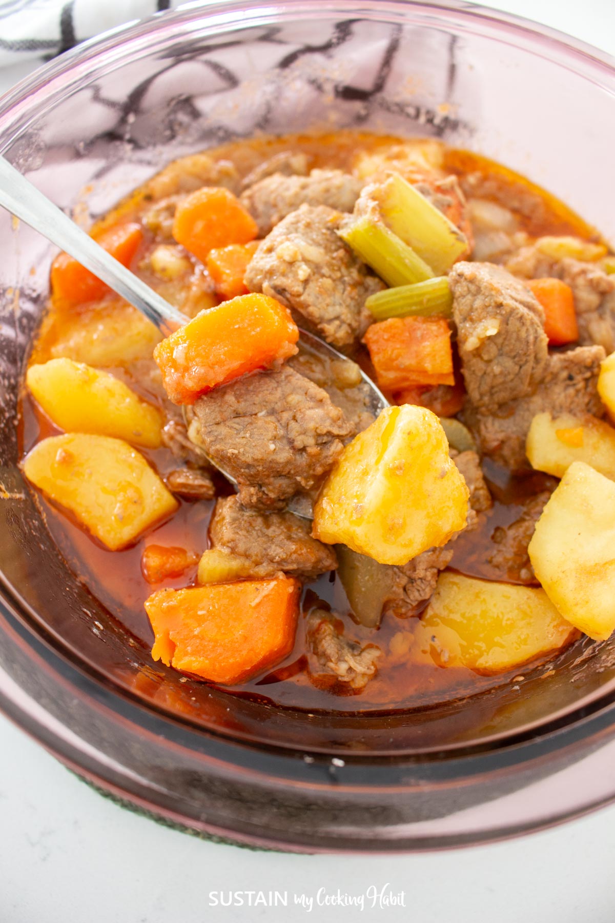 Close up of a hearty beef and vegetable goulash in a bowl.