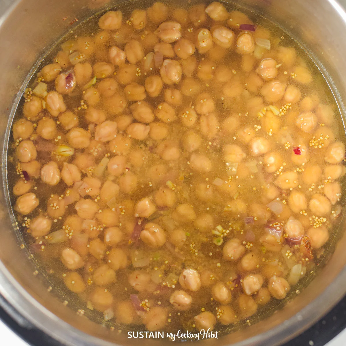 Adding broth and chickpeas to the Instant Pot.