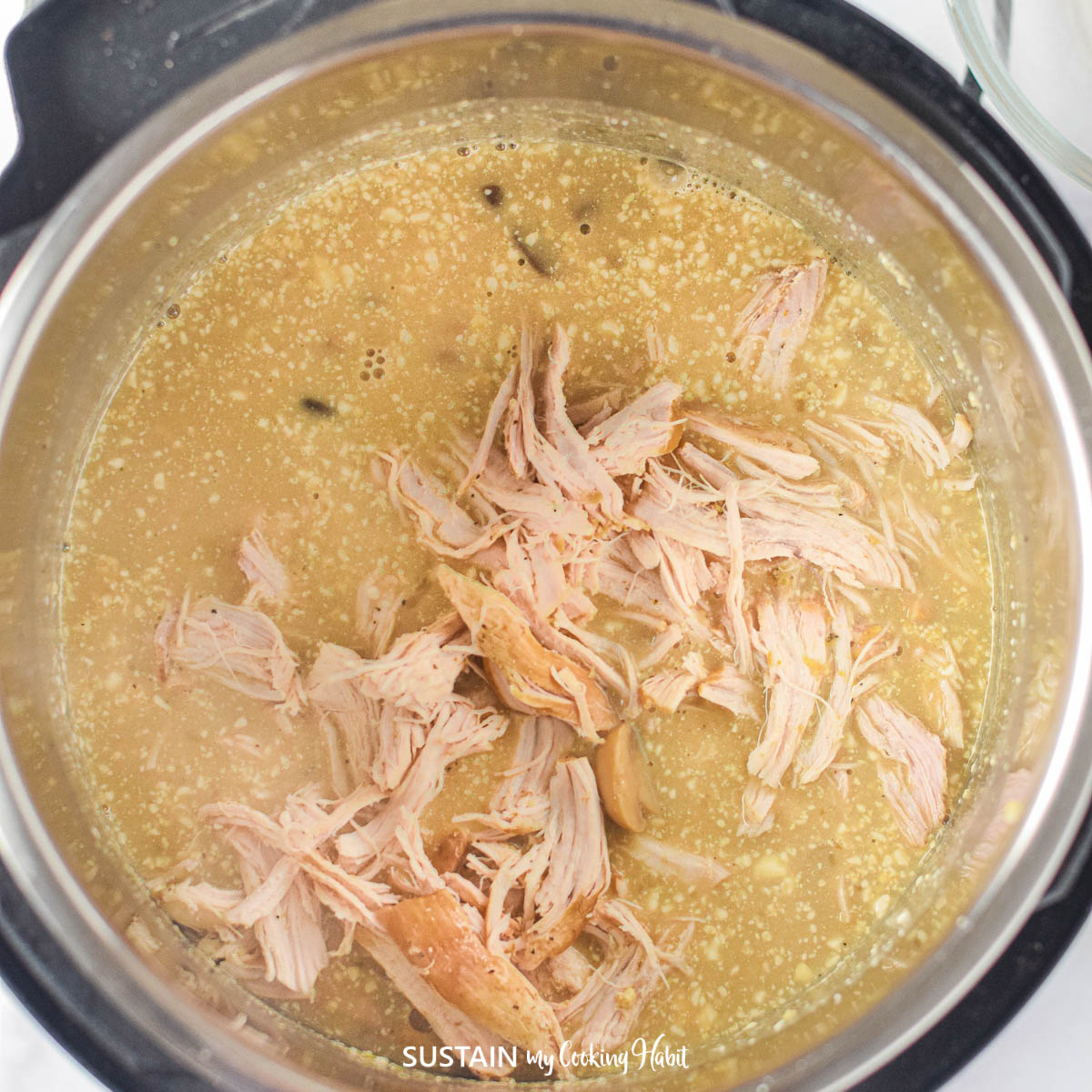 Placing shredded chicken into an Instant Pot