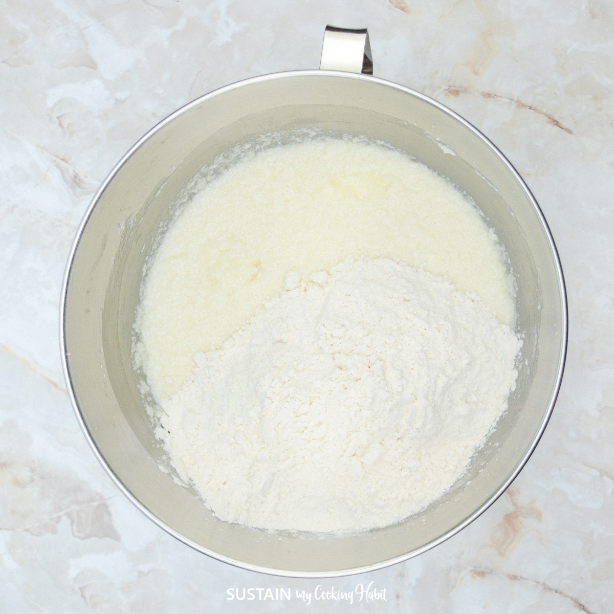 Adding flour to a bowl.