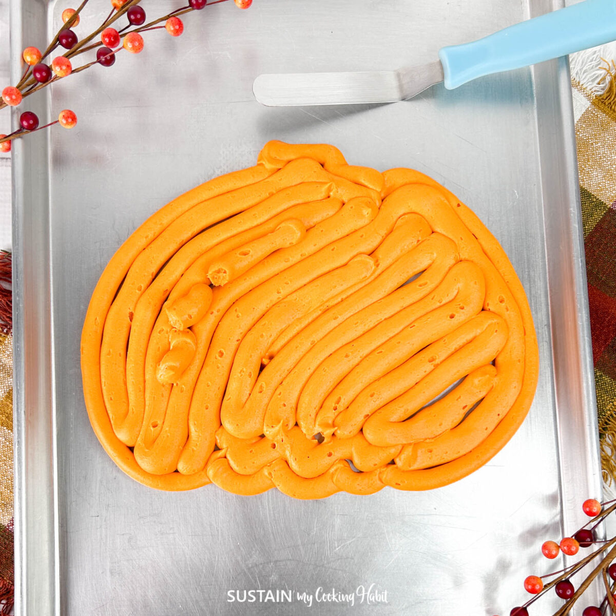 Buttercream frosting in a pumpkin shape.