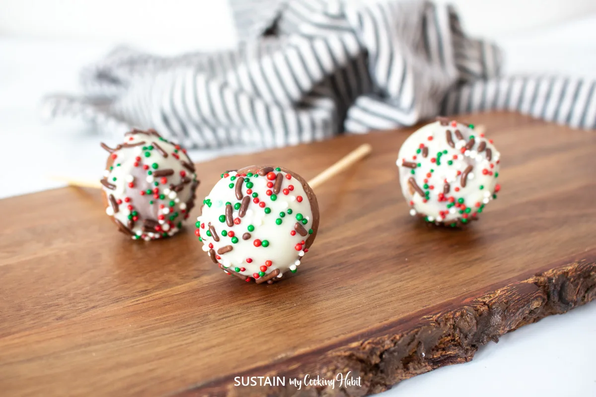 Nutella cake pops laying on a wood  board.