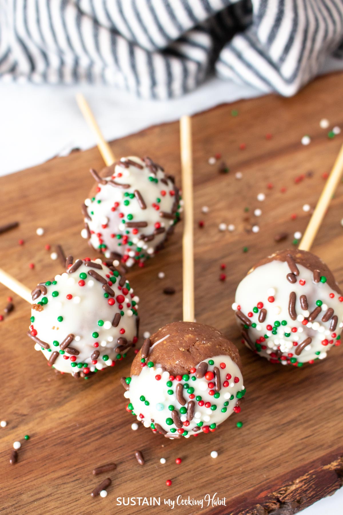 Nutella cake pops laying on a wood  board.