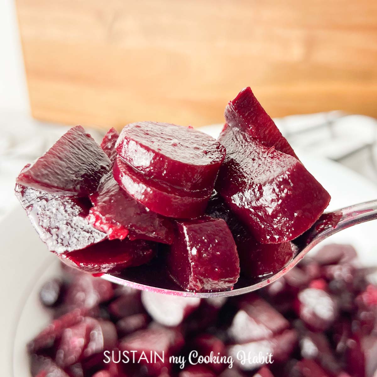 cut poeces of beets on a spoon