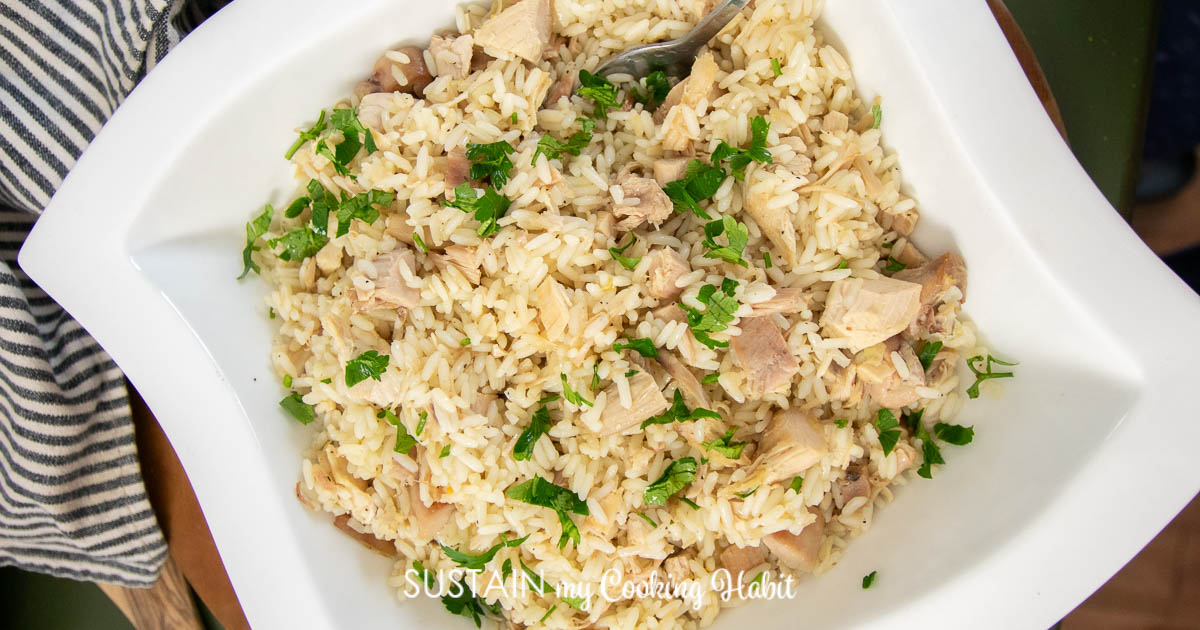 Overhead view of leftover turkey mixed with cooked rice in a bowl.