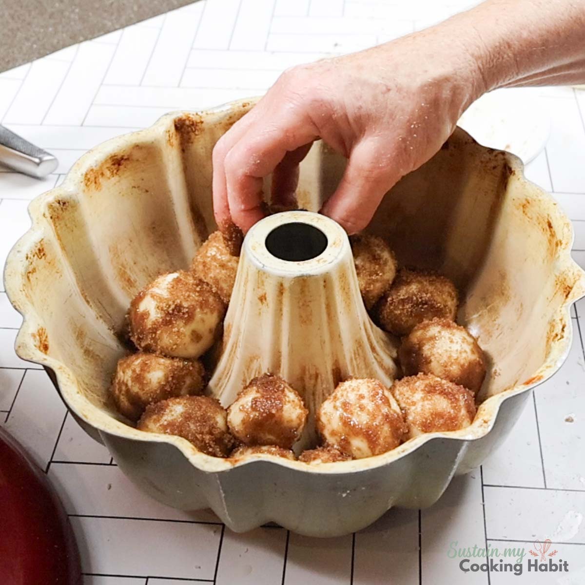 Placing cinnamon rolls into bundt pan. 