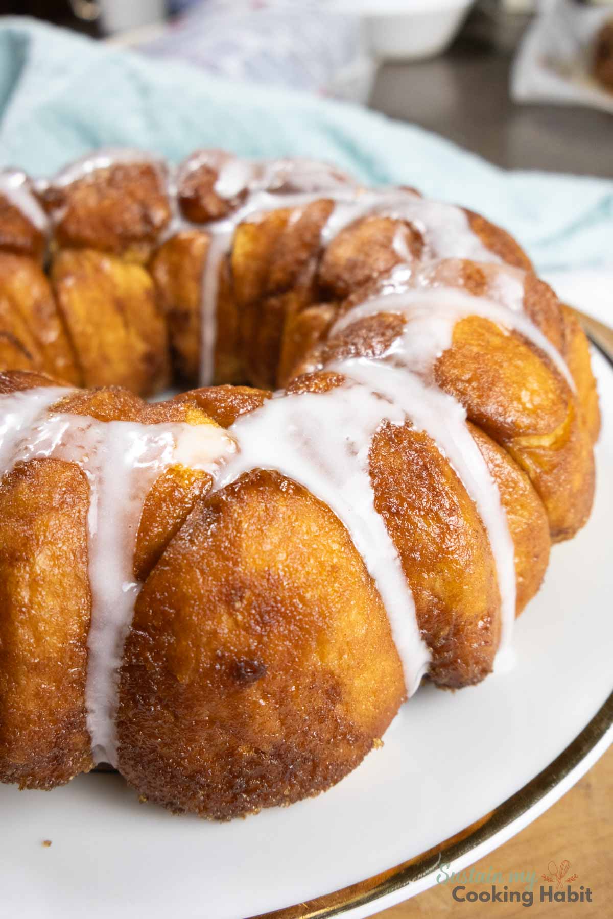 Close up of monkey bread drizzled with icing. 