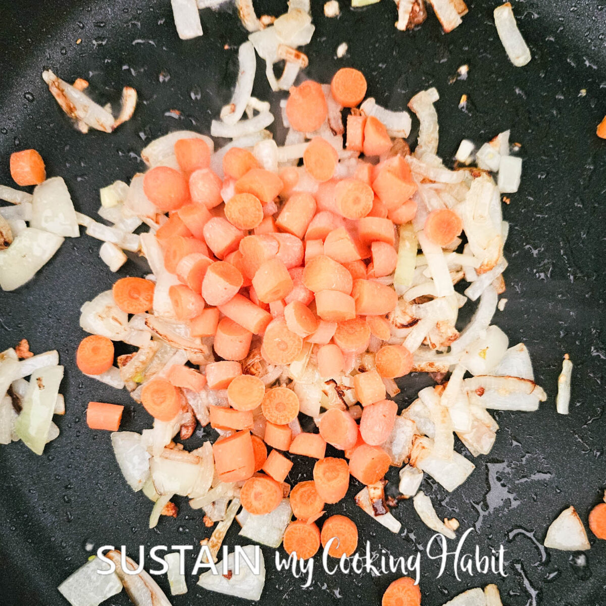 Carrots, onion and garlic in a pan. 