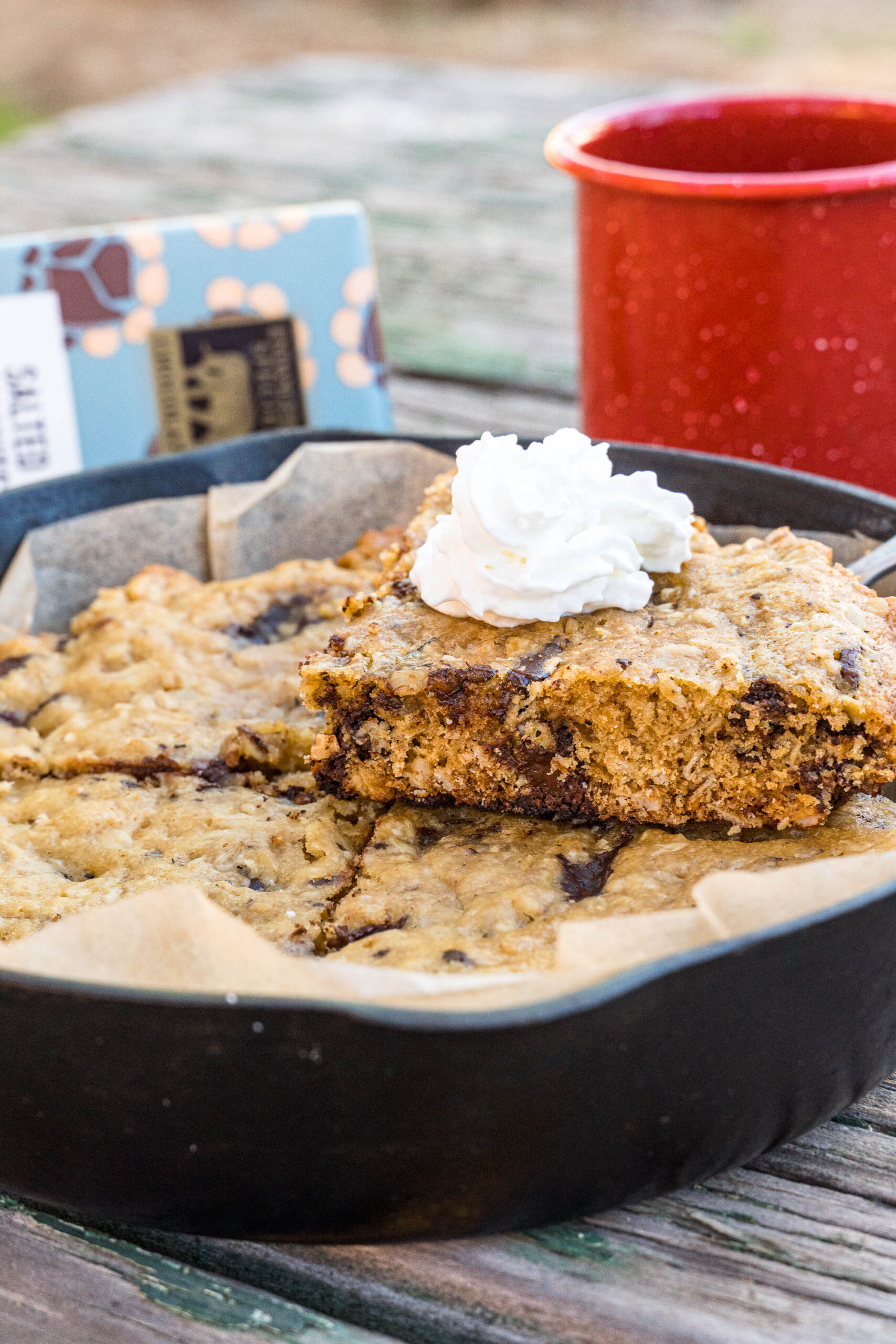 skillet of baked large cookie topped with whip cream