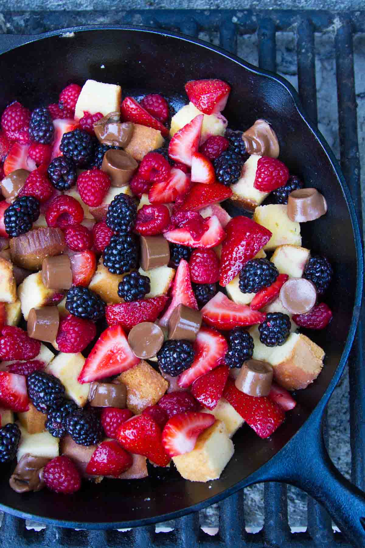 skilllet filled with baked pound cake and mixed berries
