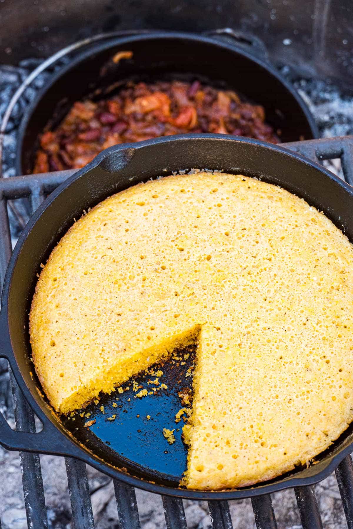 skillet filled with cornbread and a slice removed