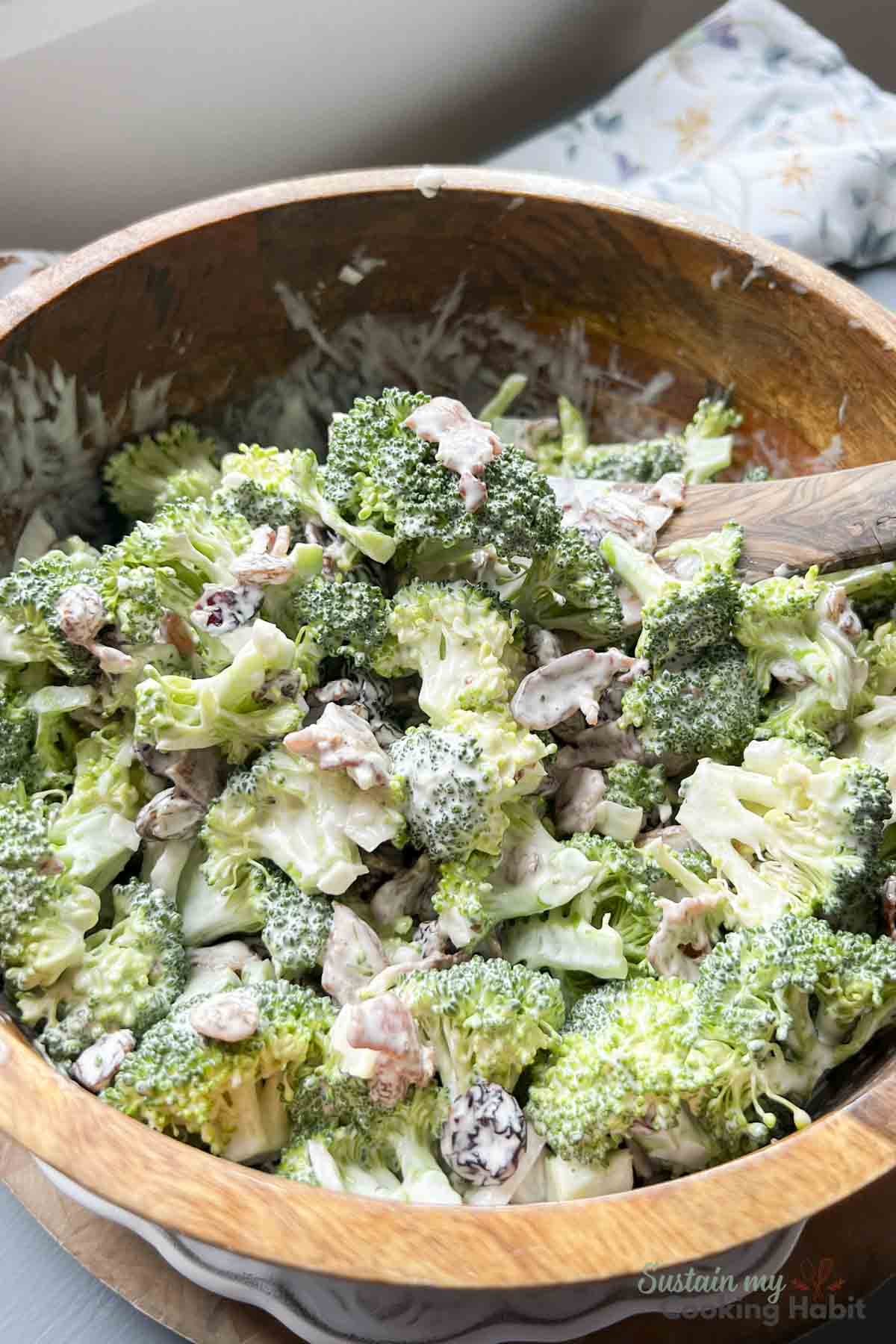 Broccoli and craisin salad in a wood bowl.