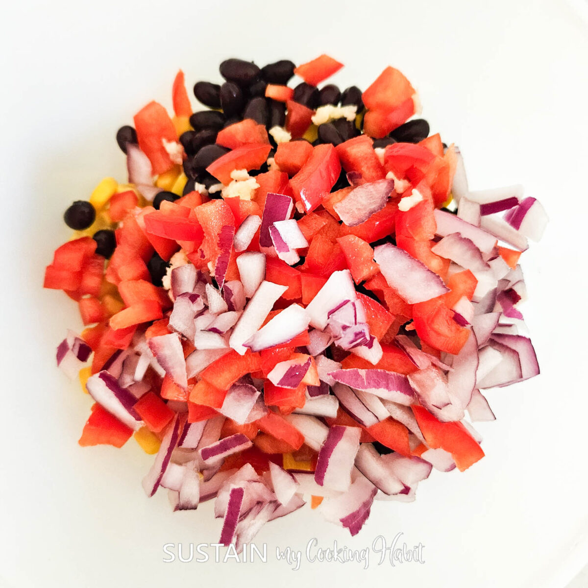 Mixing vegetables together in a bowl. 