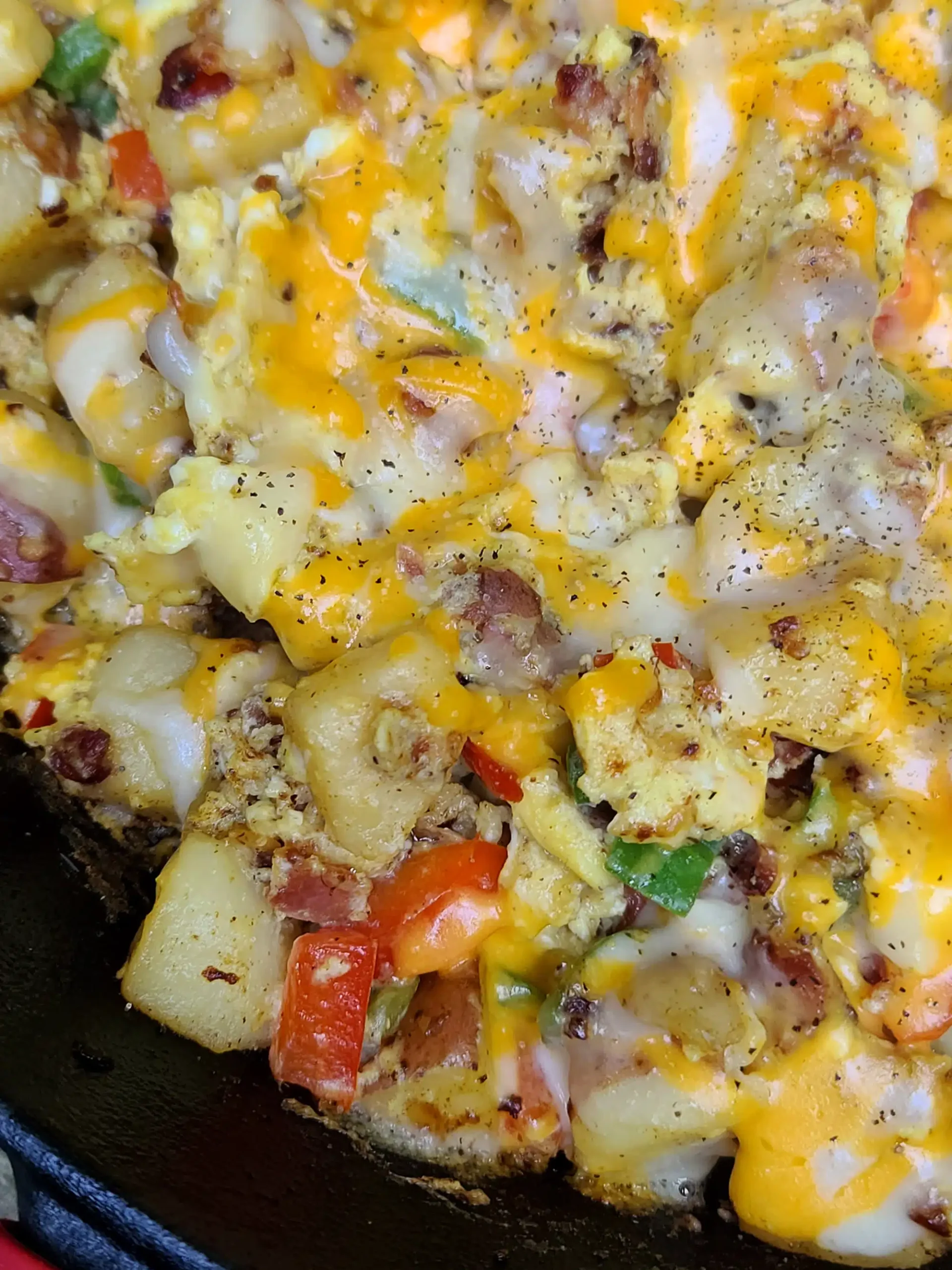 breakfast skillet with cheesy potatoes, onions and peppers