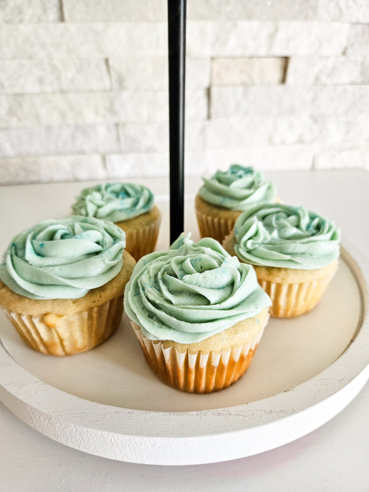 Frosted cupcakes made from scratch set on a platter.
