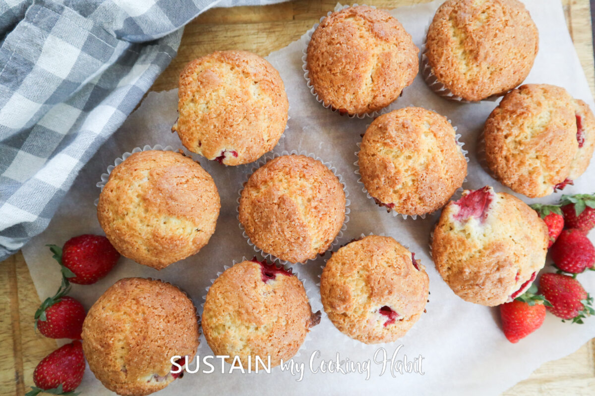 Overhead view of strawberry muffins with fresh berries.